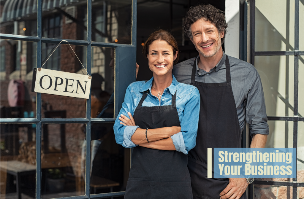 Couple in front of their own business