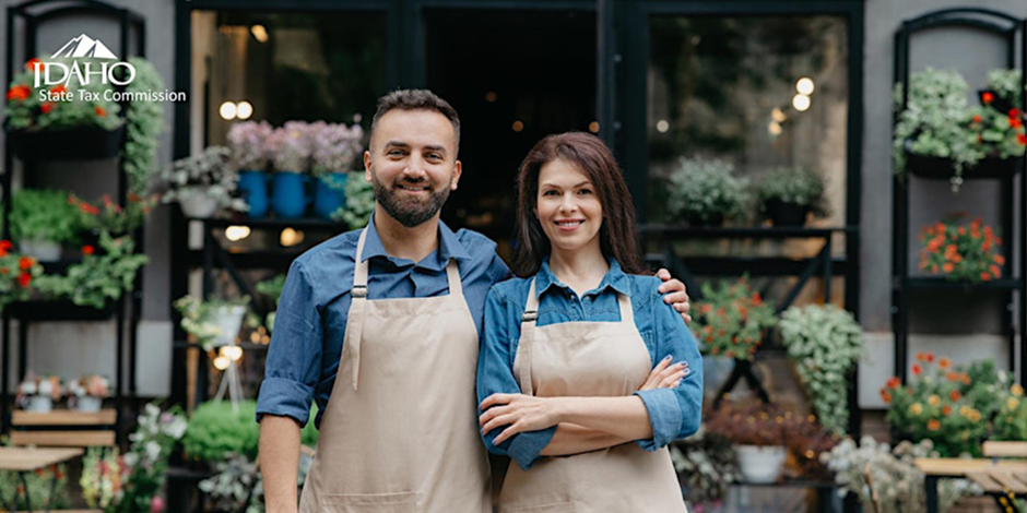Couple in front of their own business